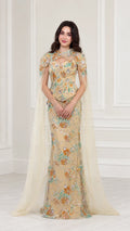 Front full view of Champagne floral embroidered evening gown with attached floor-length cape