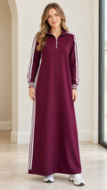 Front view of woman wearing burgundy half-zip striped sweatshirt maxi dress