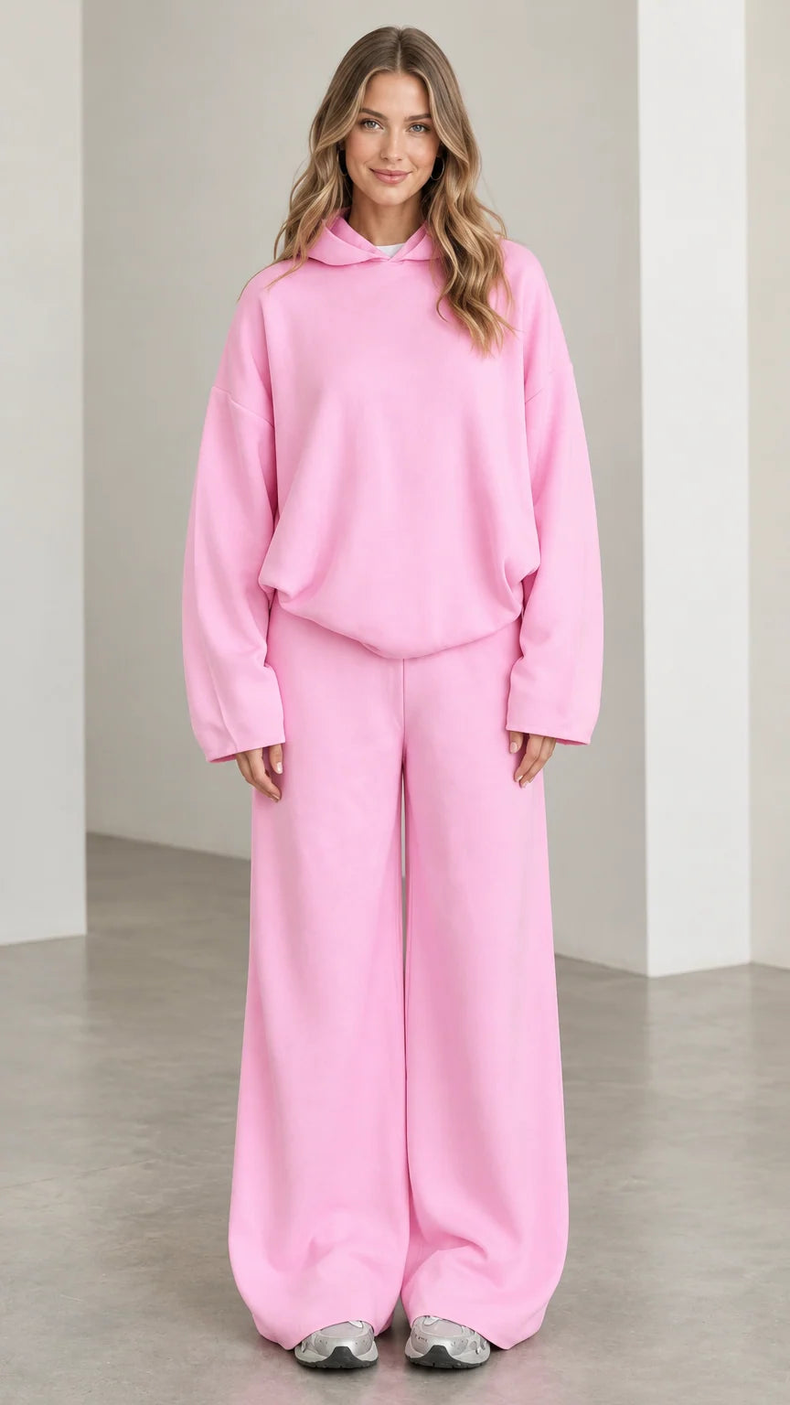 Front full-length view of woman wearing Light Pink oversized hoodie and wide leg lounge pants set