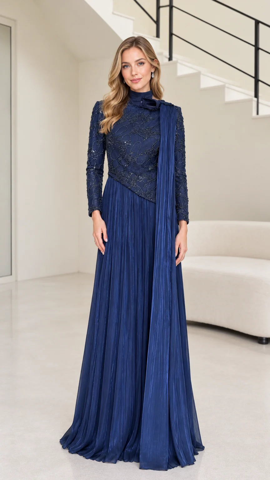 Front full-length view of navy blue long sleeve beaded evening maxi gown with pleated skirt and shoulder drape