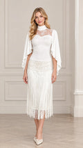Front view of model wearing white mock neck illusion lace fringe midi dress with cape sleeves