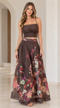 Front full view of woman wearing chocolate brown floral ruched crop top and maxi skirt set