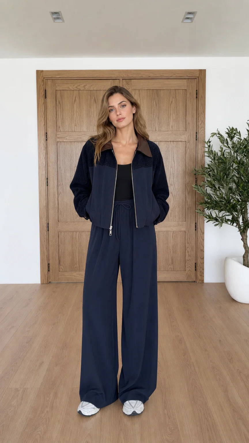 Front view of model wearing navy blue contrast collar zip jacket and wide leg pants set