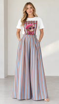 Front view of woman wearing white graphic tee and mocha blue striped wide-leg pants set