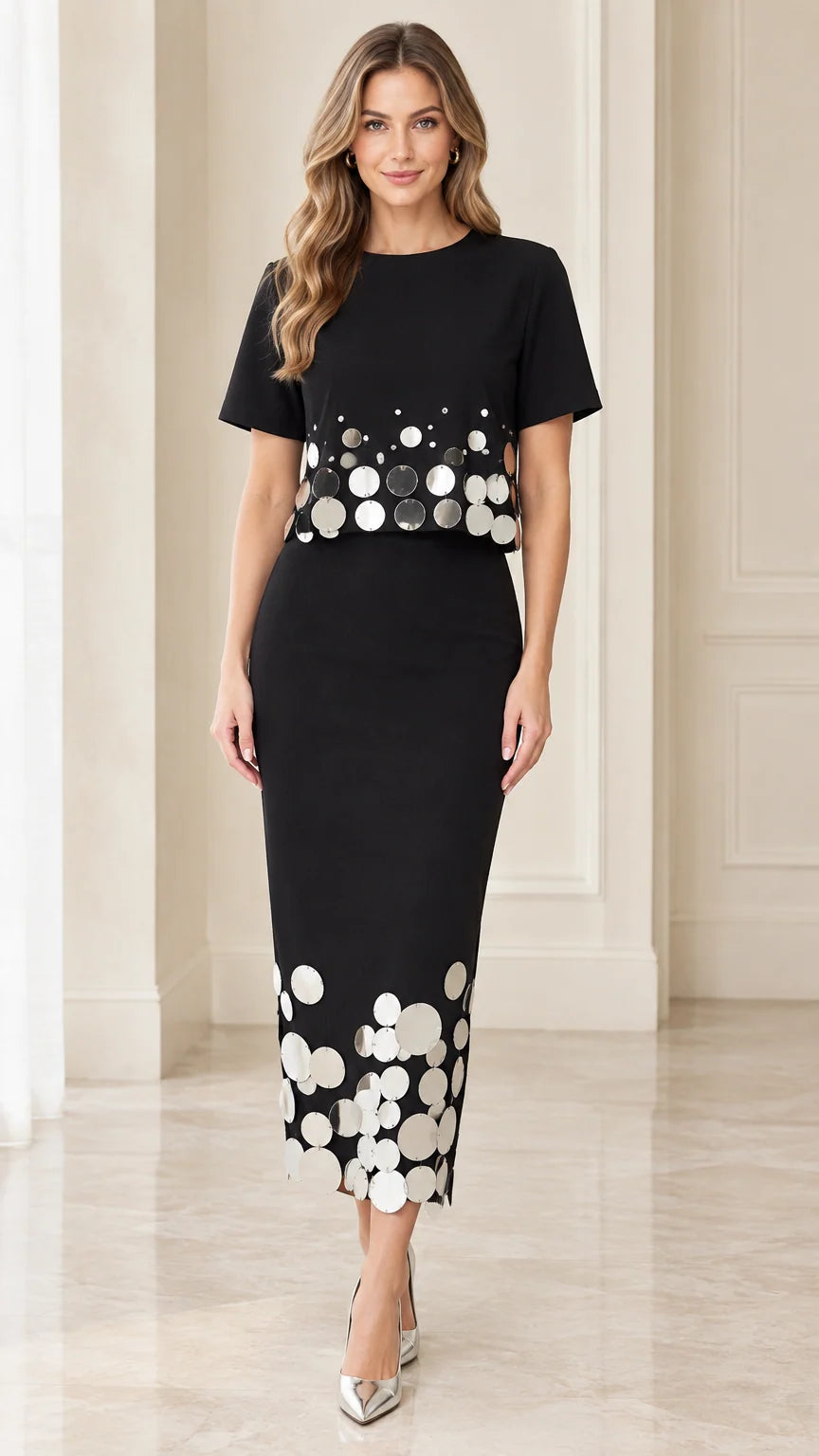 Front view of black short-sleeve midi dress with metallic disc embellishments