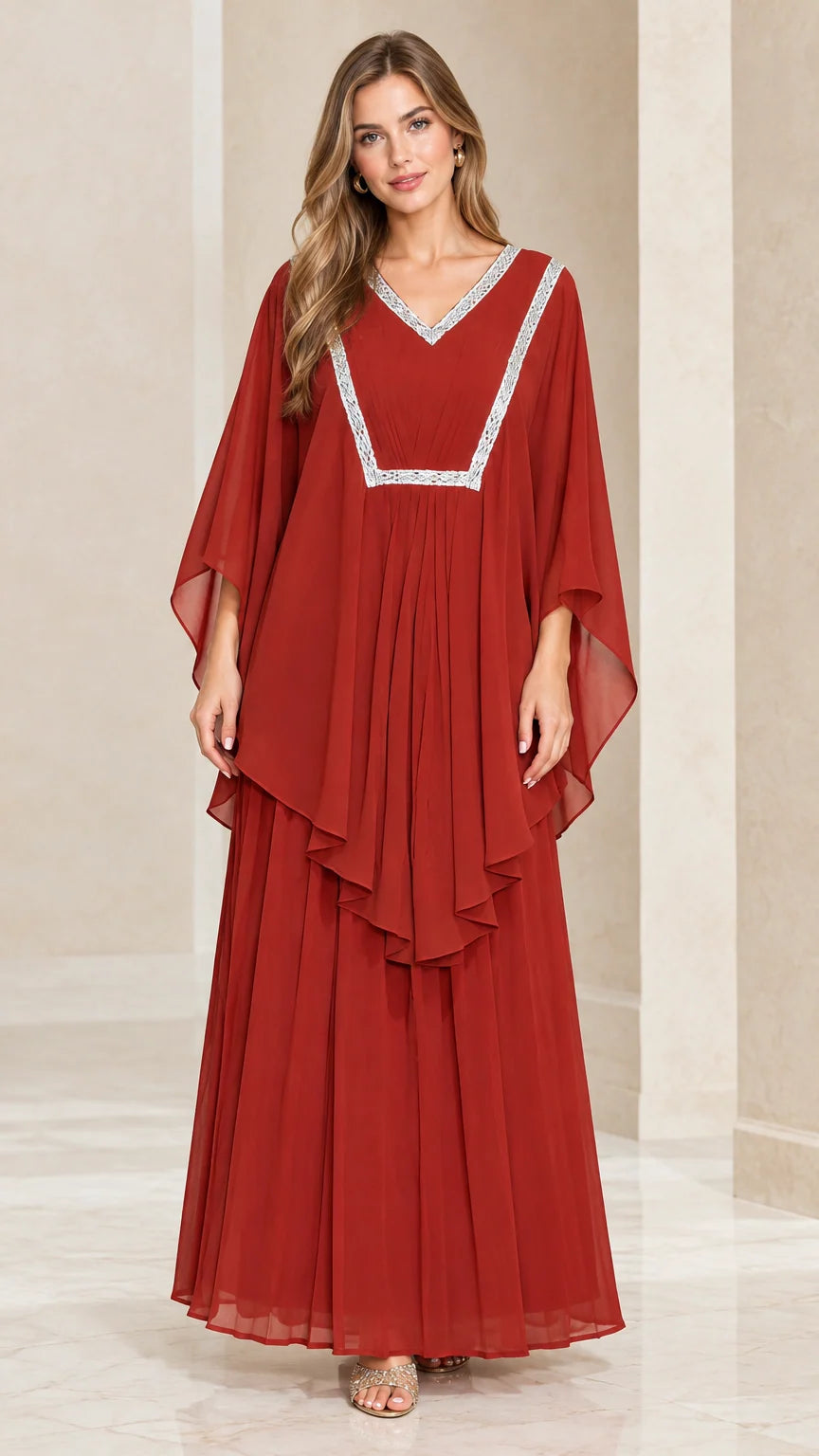 Front view of woman wearing rust red layered kaftan maxi dress with silver embroidered V-neck