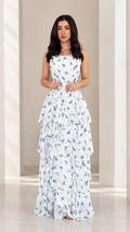 Front view of model wearing white floral tiered spaghetti strap maxi dress