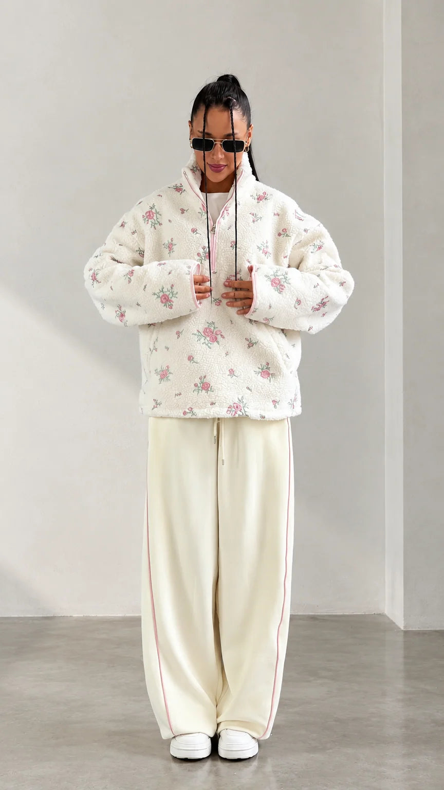 Front view of model wearing cream floral print half-zip sherpa fleece pullover