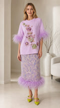 Front view of model wearing lavender feather trim top and midi skirt co-ord set