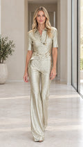 Front view of model wearing champagne gold metallic shimmer belted short sleeve jumpsuit