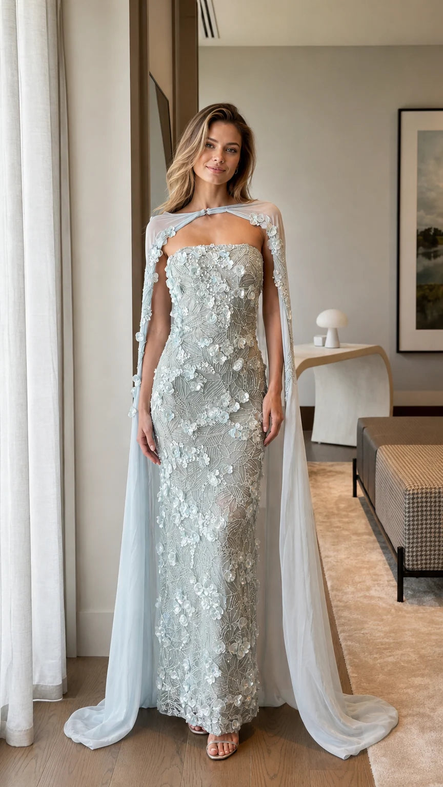 Front view of model wearing Ice Blue 3D floral applique strapless gown with sheer cape