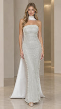 Front view of model wearing silver strapless beaded evening gown with matching neck scarf cape