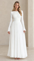 Full front view of model wearing white pleated long sleeve maxi evening dress