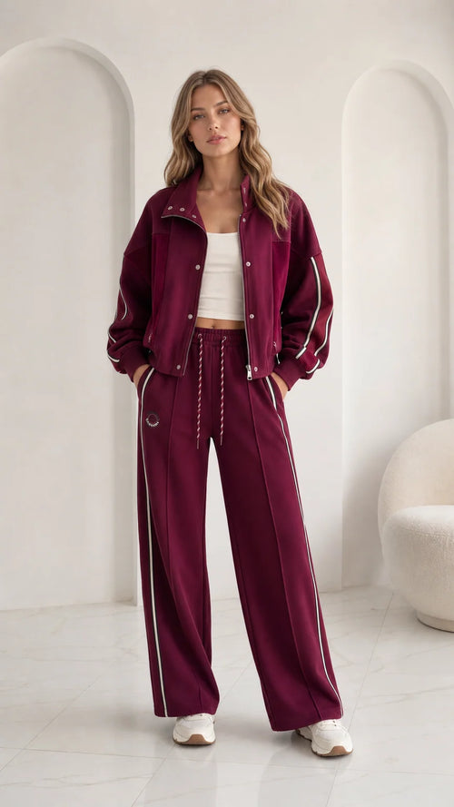 Women's burgundy 2-piece tracksuit set with zip jacket and wide leg pants front view