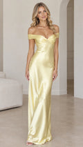 Front view of woman wearing butter yellow off-the-shoulder satin maxi dress