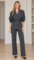 Full front view of women's charcoal grey pinstripe wrap blazer and trousers suit set