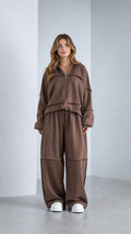 Front view of model wearing Chocolate Brown raw-edge zip jacket and wide-leg sweatpants set
