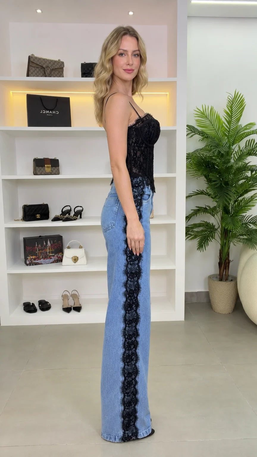 Side view of model showing black lace side trim on straight-leg denim jeans