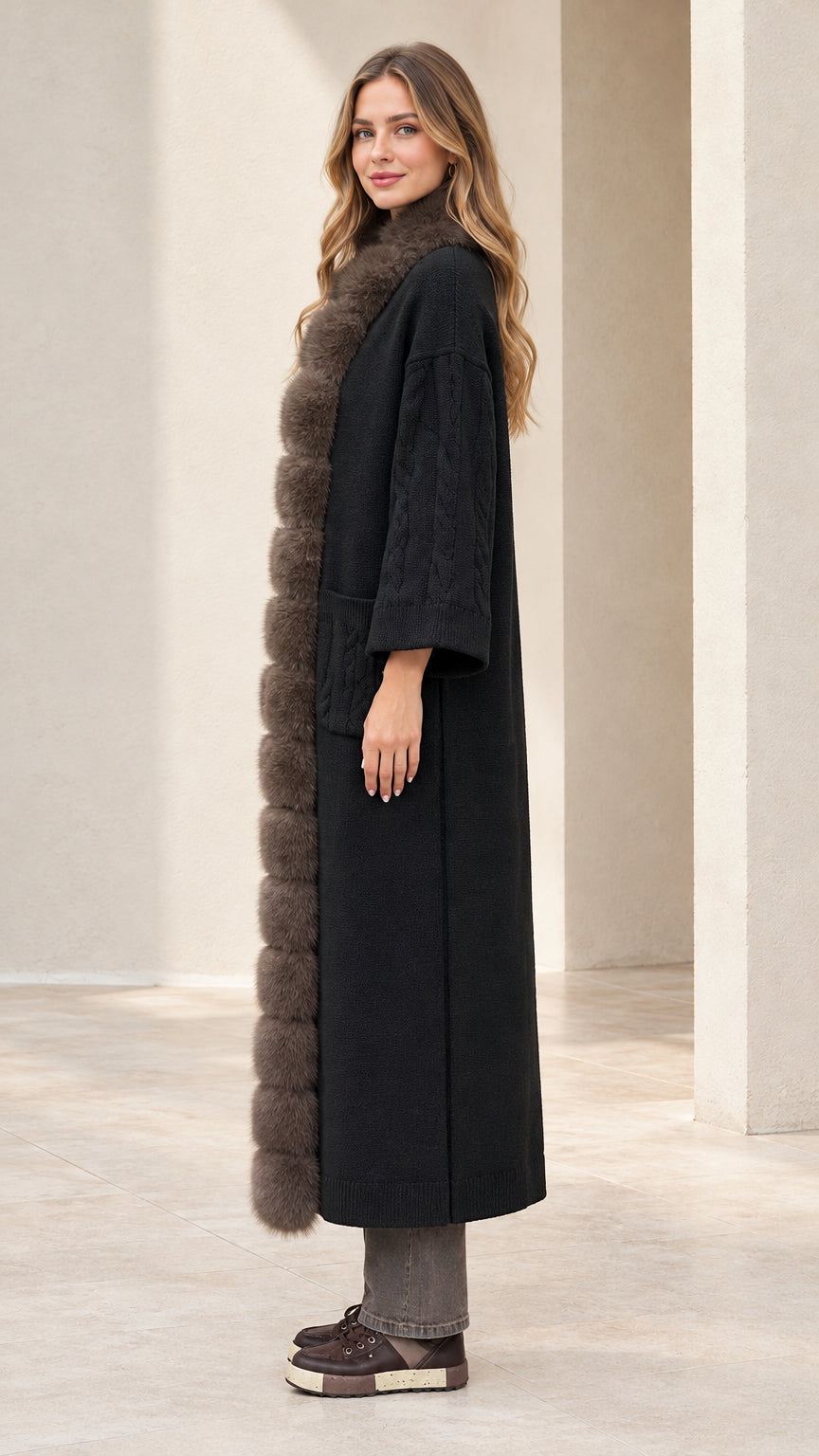 Side profile view of black faux fur trimmed long cardigan coat