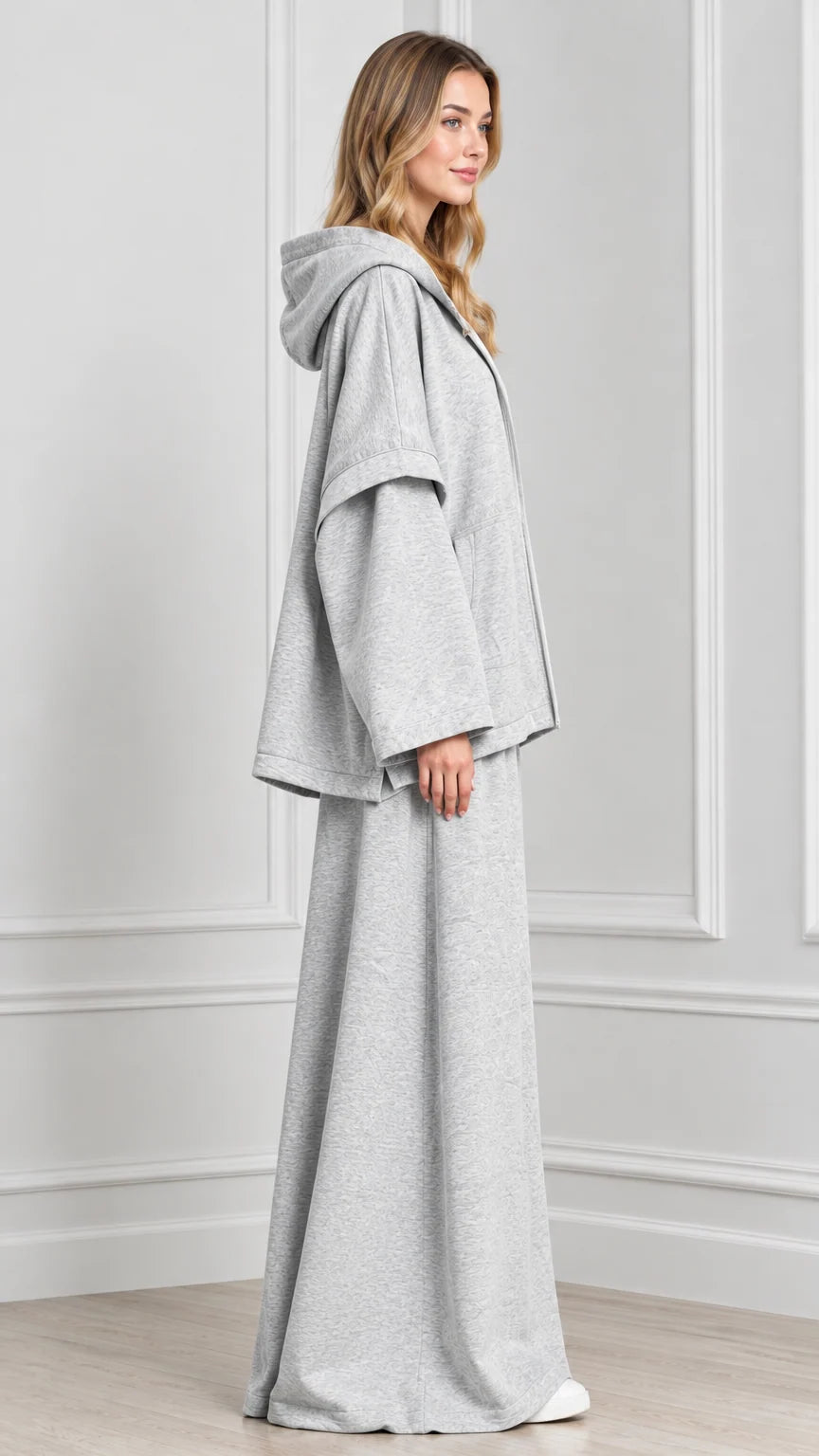 Side profile of woman wearing Heather Grey hooded cape jacket matching pants set