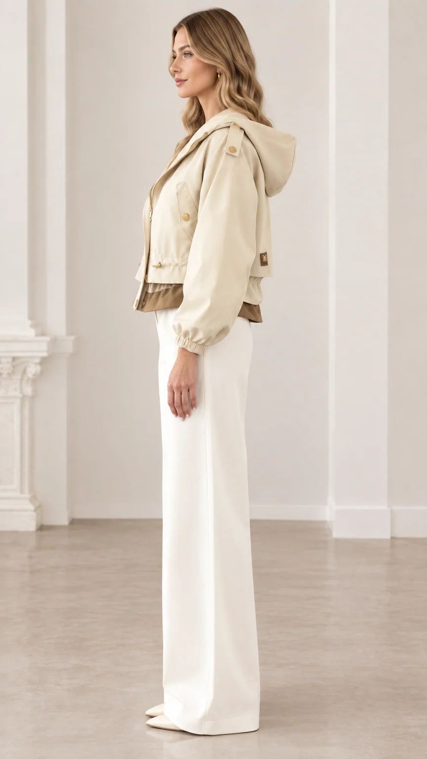 Side profile of woman wearing beige cropped hooded utility jacket