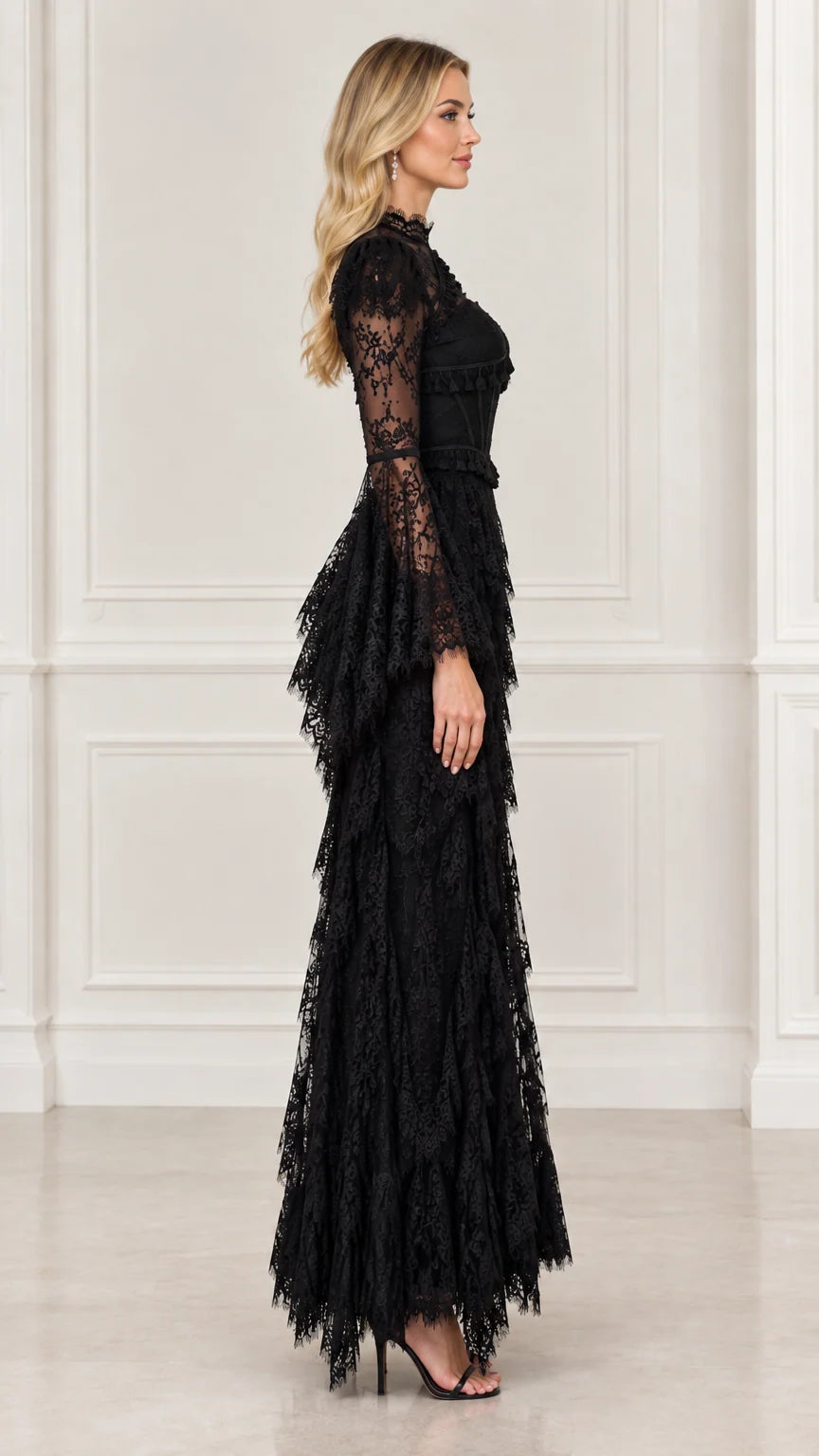Side view of black long sleeve lace evening dress with tiered fringe maxi skirt