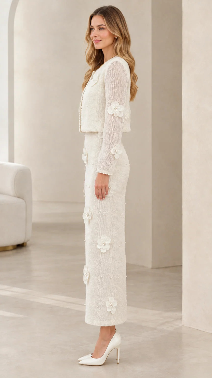 Side profile view of model wearing ivory floral applique tweed skirt suit