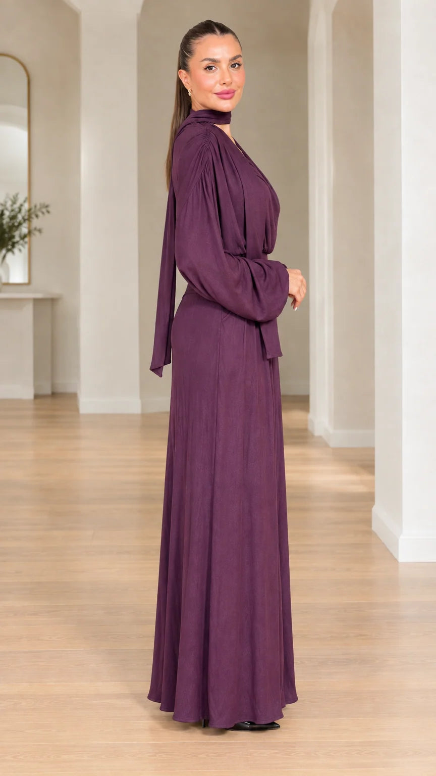 Side view of model in plum elegant wide-leg evening jumpsuit