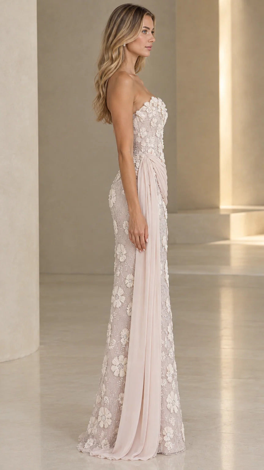 Side profile view of blush floral embroidered formal gown with flowing side train