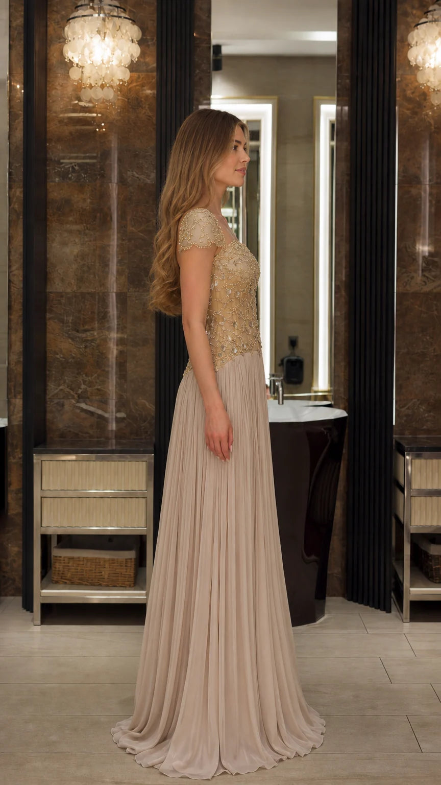Side profile view of the Champagne beaded floor length formal evening gown