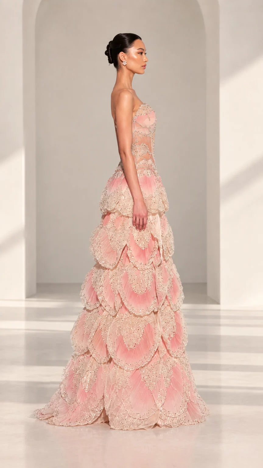 Side profile view of Blush Pink strapless formal gown showing voluminous tiered skirt