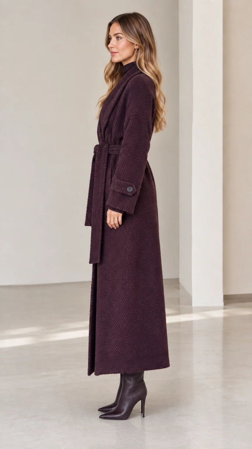Side profile of woman wearing deep plum full length wrap coat