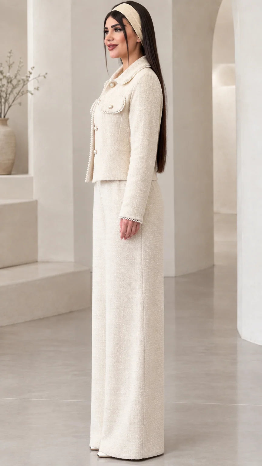 Side profile view of model showcasing the tailored silhouette of the cream tweed two-piece pant set