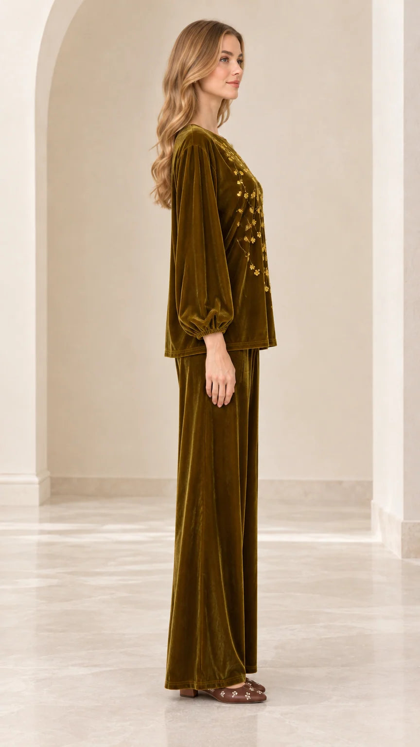 Side view of model wearing olive green velvet balloon sleeve top and wide leg pants