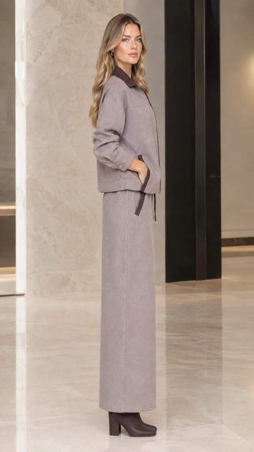 Side profile view of woman in Taupe Gray jacket and maxi skirt set