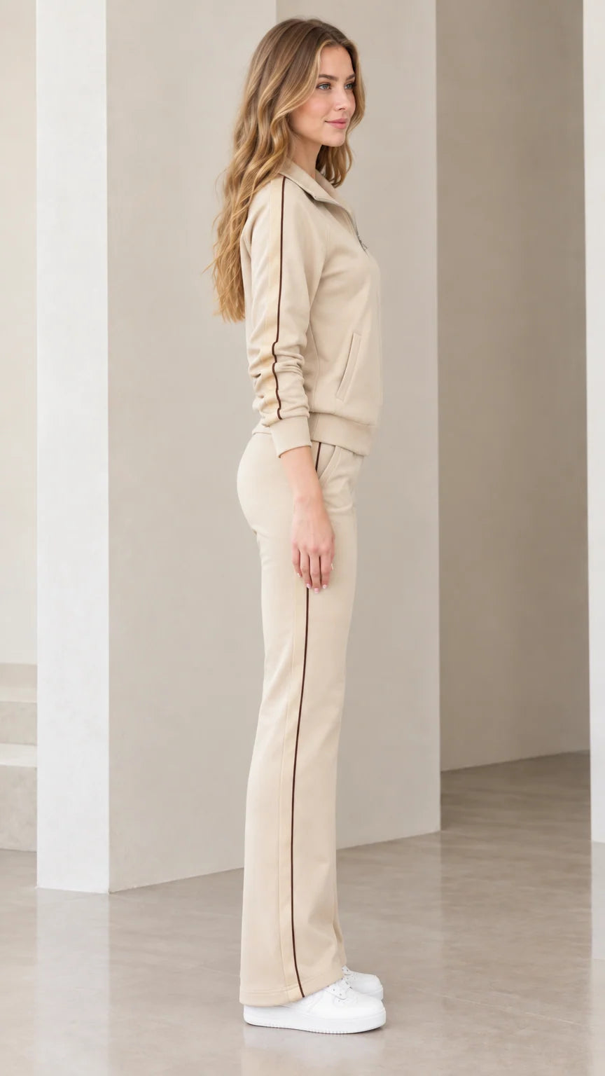Side view of beige tracksuit set showing contrast vertical stripes along jacket and pants