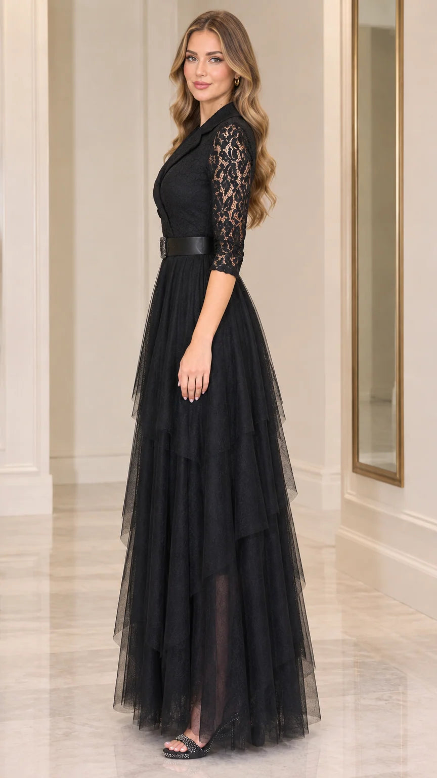 Side full-length view of model wearing black lace 3/4 sleeve tiered formal gown