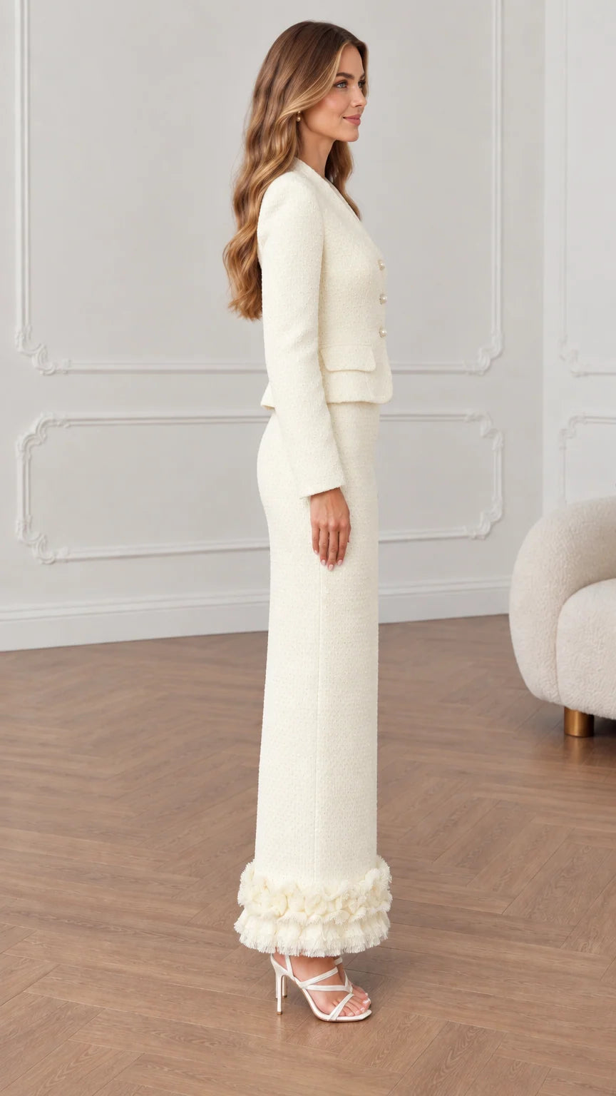 Side profile view of cream tailored tweed jacket and column maxi skirt