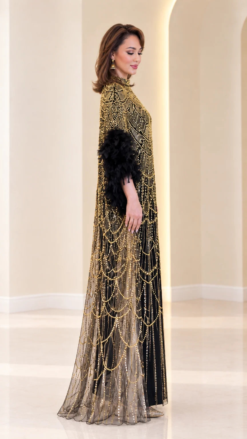 Side profile of woman wearing black and gold beaded cape gown