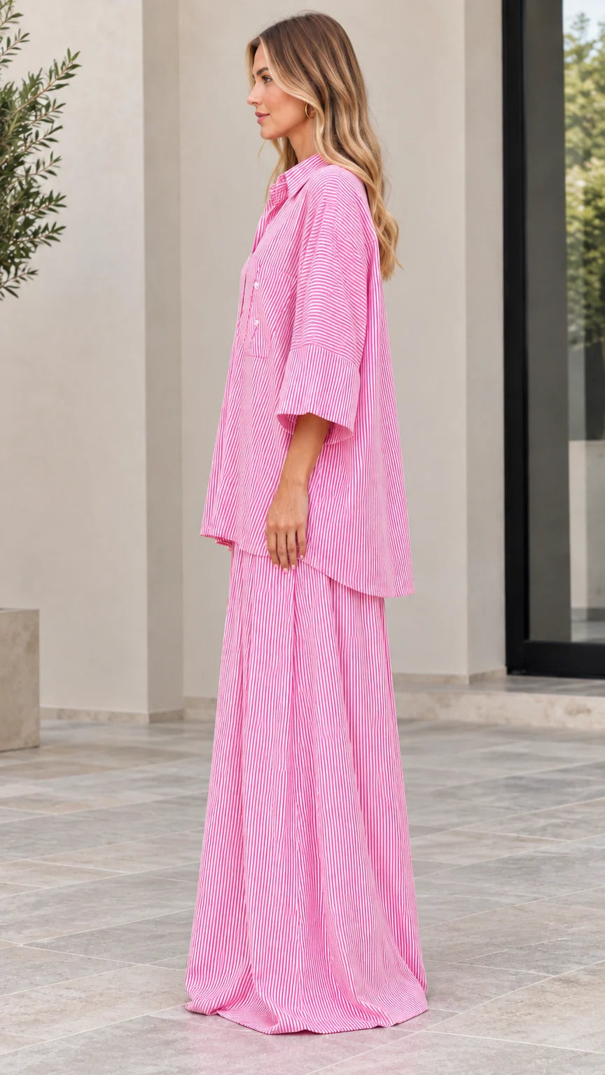 Side view of woman wearing pink vertical striped matching two-piece set