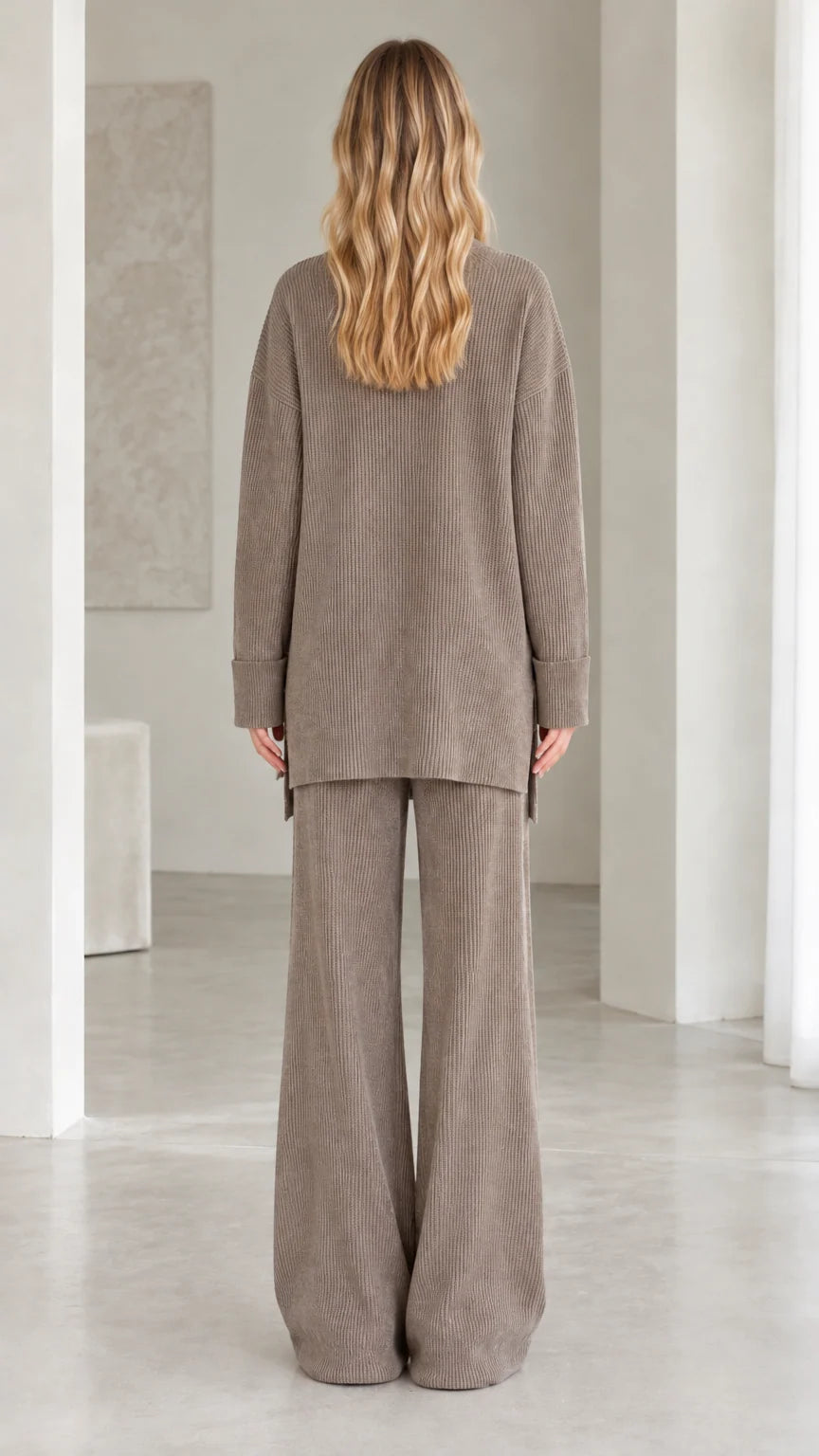 Back view of model wearing relaxed fit taupe ribbed knit two-piece set