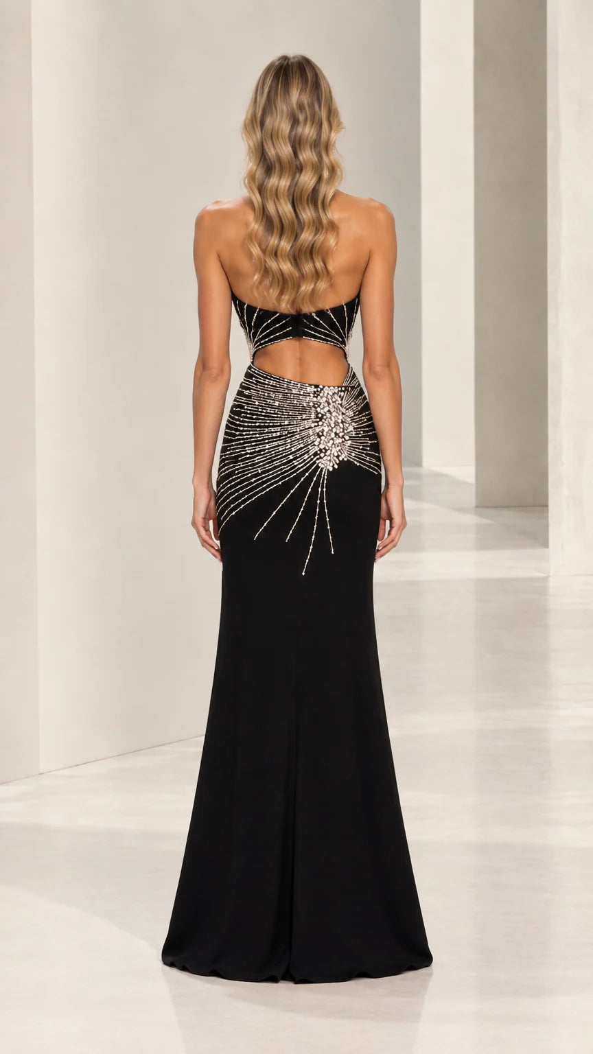 Back view of black halter neck cutout formal gown with open back design