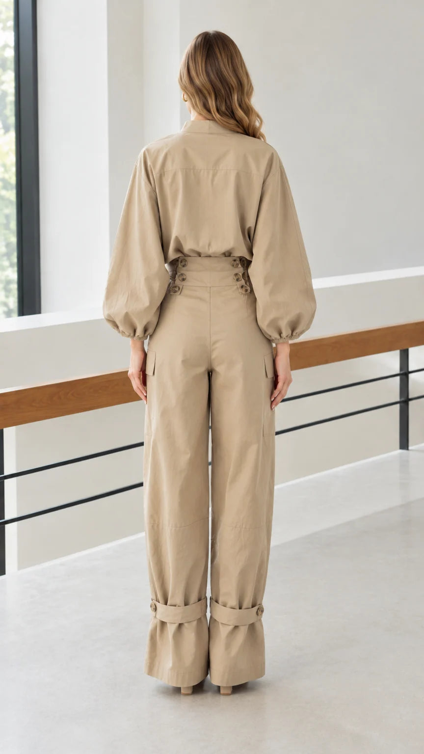 Back view of woman wearing khaki matching blouse and wide-leg pants set