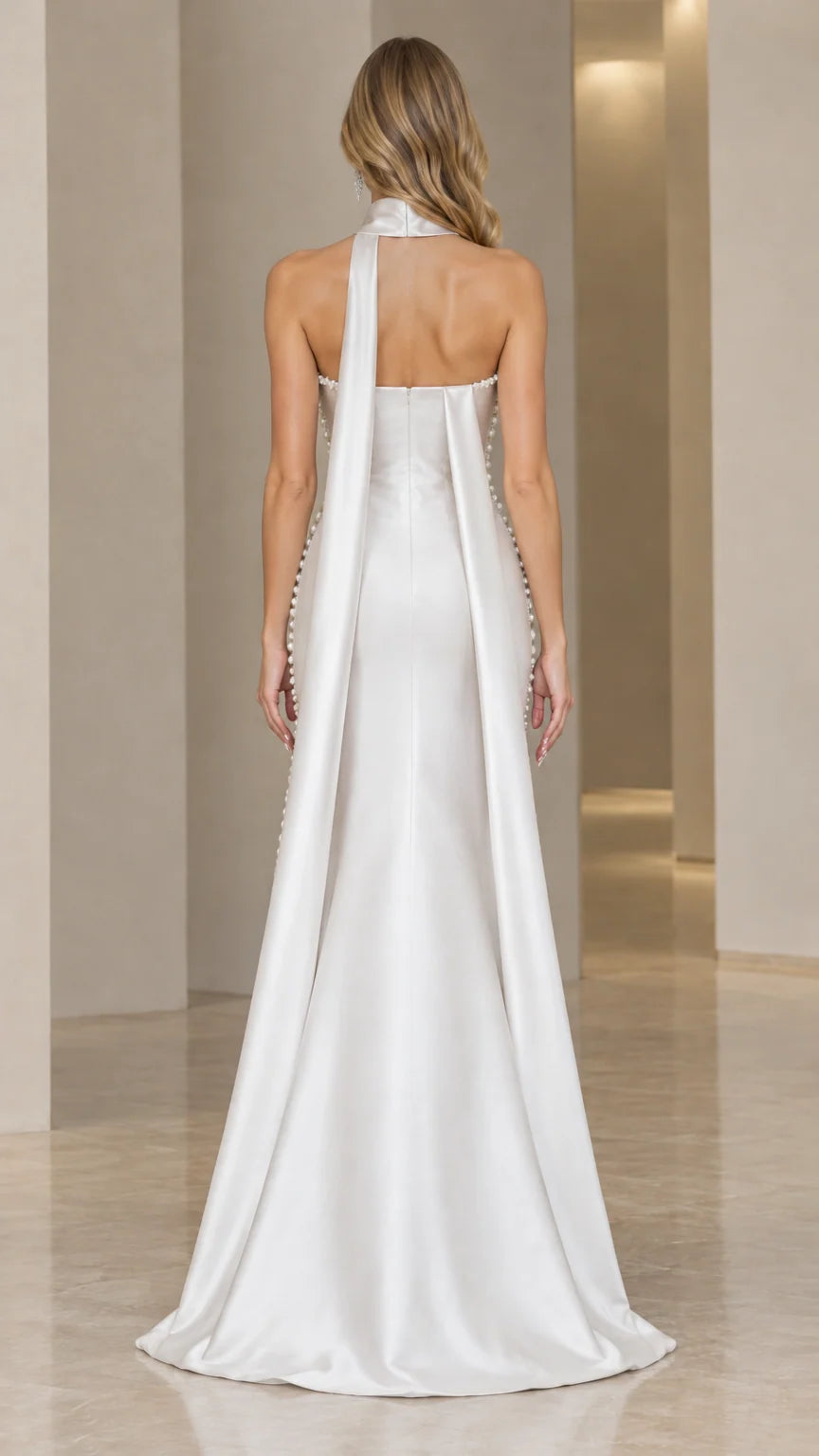 Back view of model showing elegant white satin-finish cape train and straight backline
