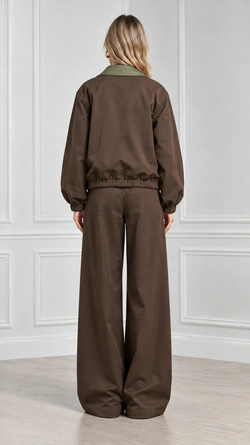 Back view of model showcasing brown elastic hem jacket and wide leg trousers