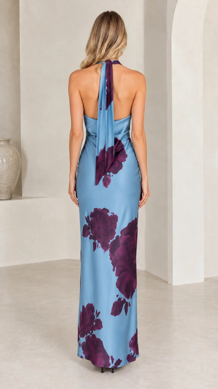 Back view of dusty blue halter maxi dress highlighting flowing tie-back scarf