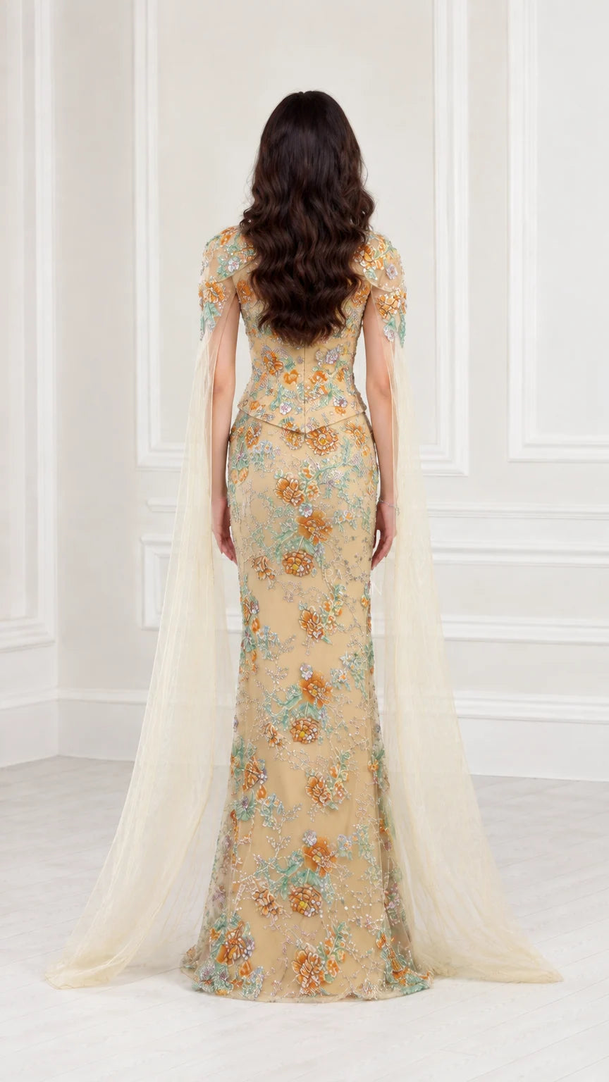 Back view of Champagne floral sequin formal gown with flowing cape