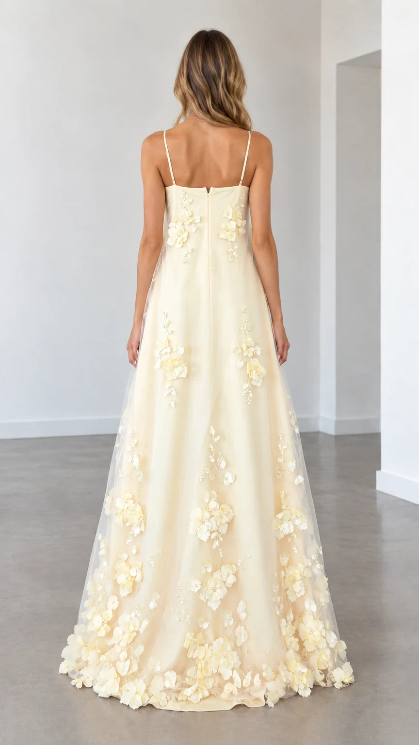 Model wearing butter yellow spaghetti strap evening gown back view