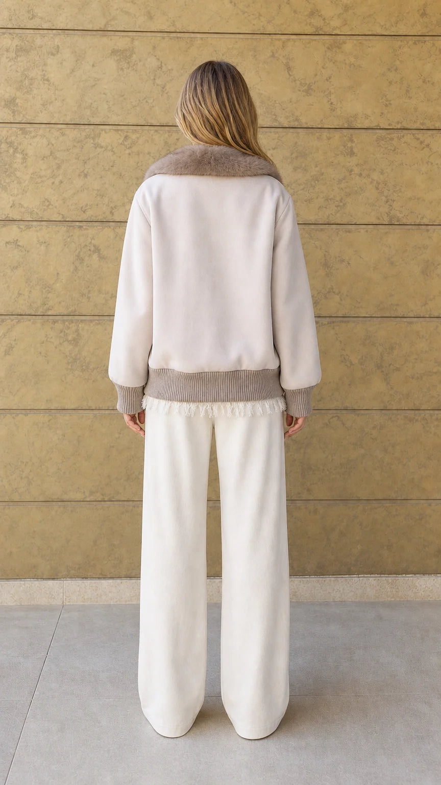 Back view of cream relaxed fit jacket with ribbed hem