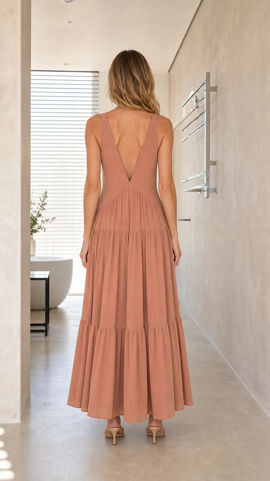 Model wearing Dusty Rose maxi dress, back view showing V-back design